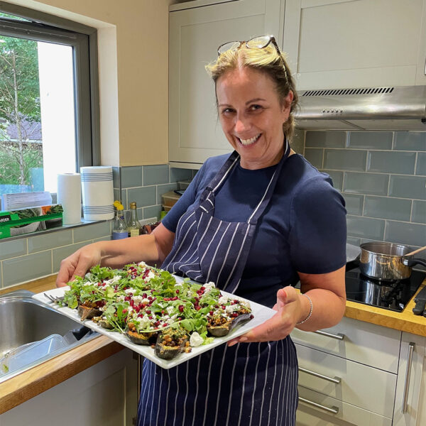 Catriona Butcher, retreat caterer carrying a tray of food